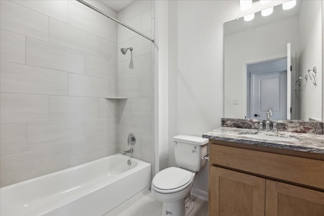 full bathroom featuring vanity, tiled shower / bath combo, and toilet