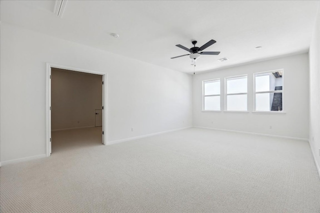 carpeted spare room featuring ceiling fan