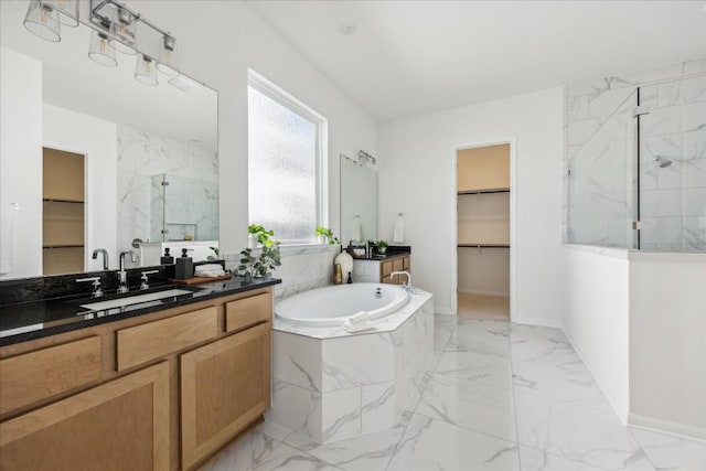 bathroom featuring plus walk in shower and vanity