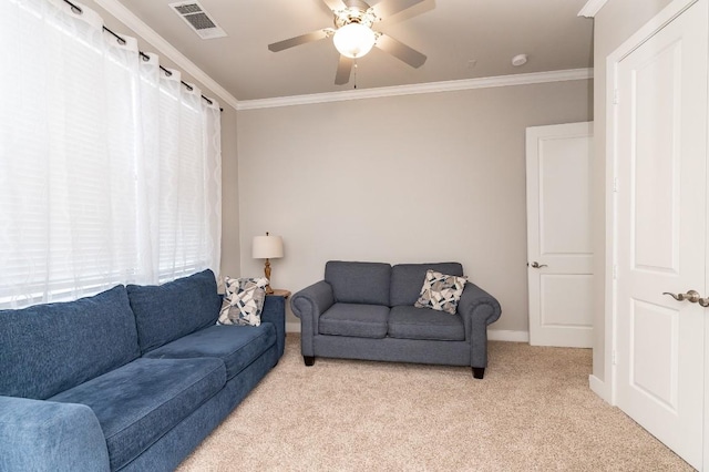 living room featuring light carpet, ceiling fan, a healthy amount of sunlight, and ornamental molding