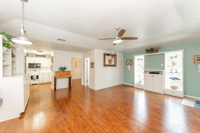 unfurnished living room featuring ceiling fan, wooden walls, light hardwood / wood-style floors, and lofted ceiling