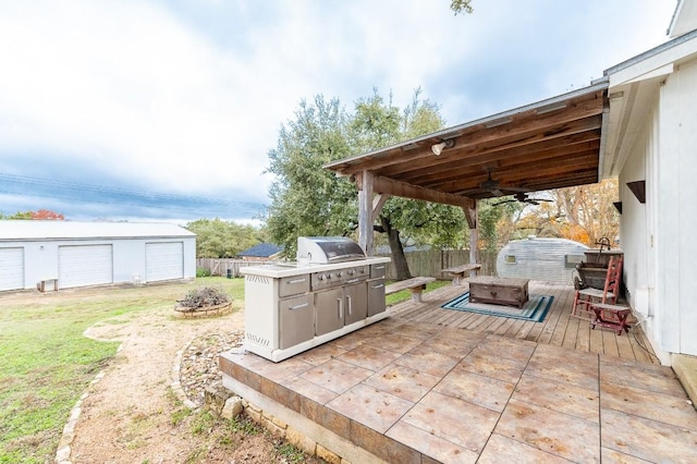 view of patio / terrace with ceiling fan, an outbuilding, a grill, a garage, and a deck