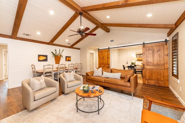 living room featuring hardwood / wood-style flooring, a barn door, wooden ceiling, and beamed ceiling