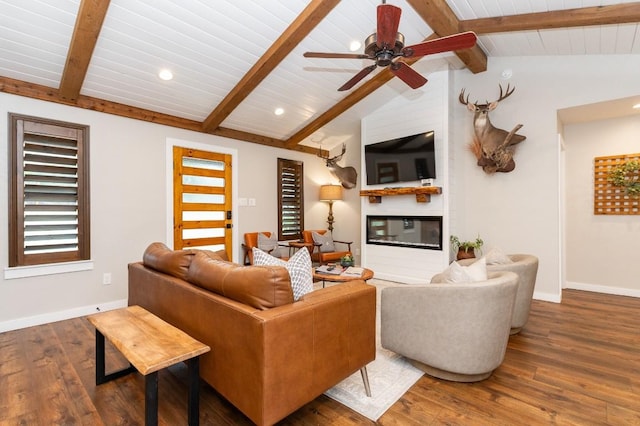 living room featuring hardwood / wood-style floors, lofted ceiling with beams, a large fireplace, and ceiling fan