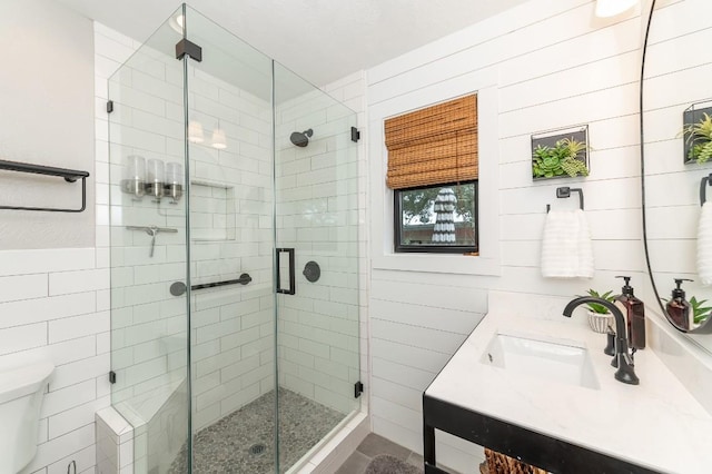 bathroom featuring vanity, toilet, and walk in shower