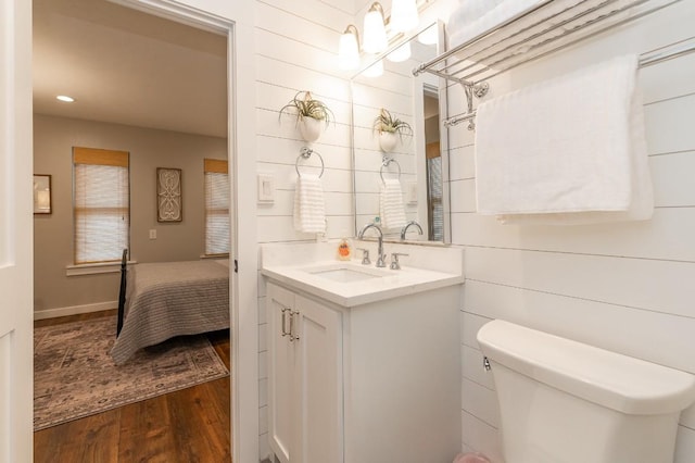 bathroom featuring hardwood / wood-style flooring, vanity, and toilet