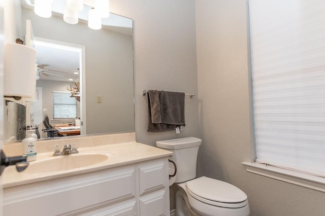 bathroom with vanity, ceiling fan, and toilet