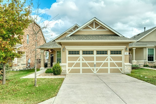 craftsman-style home featuring a garage and a front yard