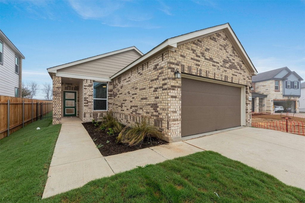 view of front of home with a garage and a front lawn