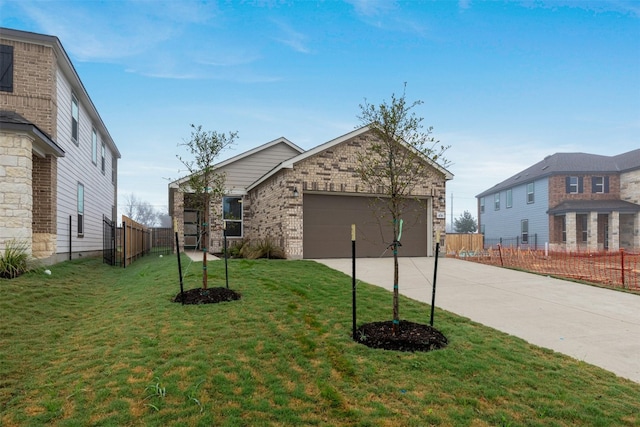 view of front of home with a front yard and a garage