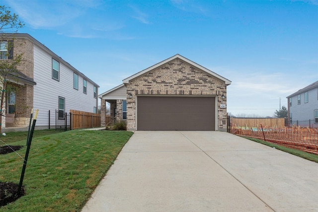 view of front of house featuring a garage and a front lawn