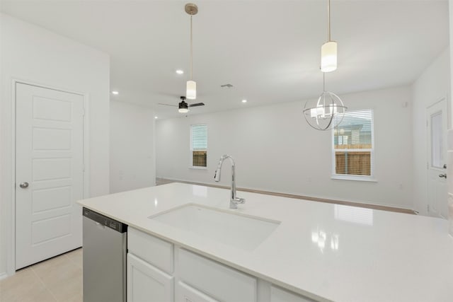 kitchen featuring stainless steel dishwasher, ceiling fan with notable chandelier, sink, pendant lighting, and white cabinets