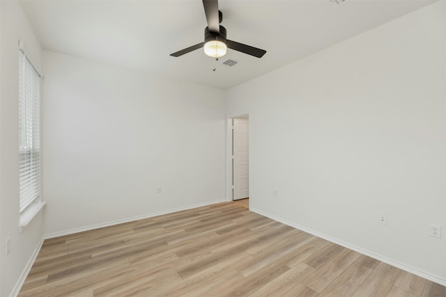 spare room featuring light wood-type flooring and ceiling fan