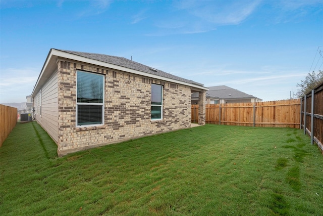 back of house with a lawn