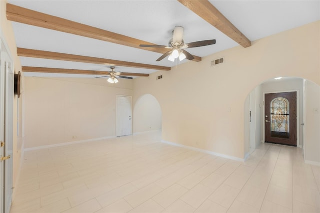 empty room featuring beam ceiling and ceiling fan