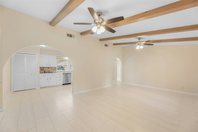 empty room featuring beam ceiling and ceiling fan