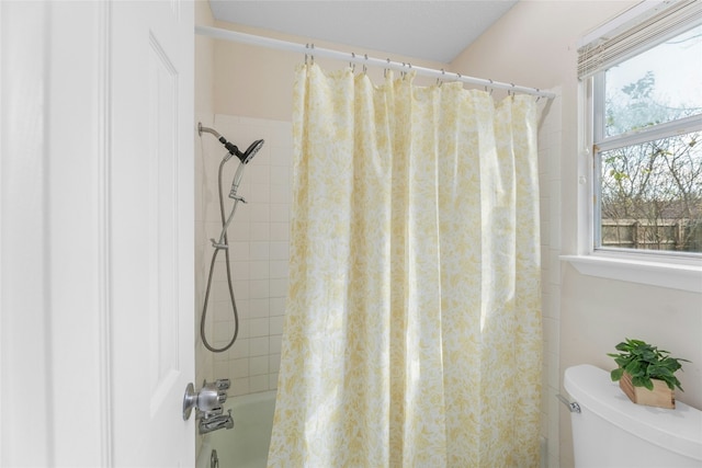 bathroom featuring toilet and shower / tub combo