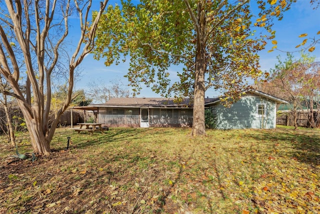 rear view of house with a lawn