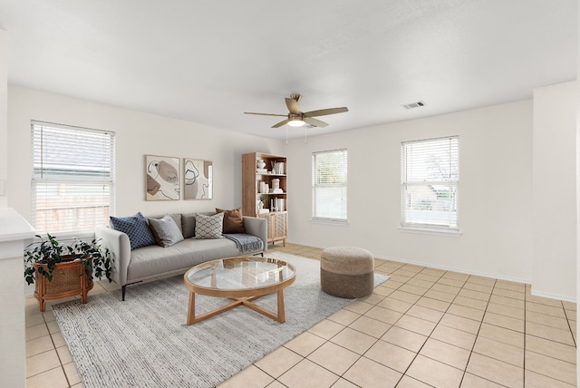 tiled living room with ceiling fan