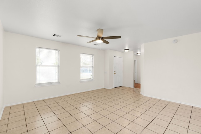 tiled empty room with ceiling fan