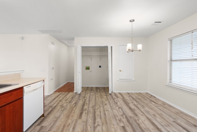 kitchen featuring a chandelier, pendant lighting, light wood-type flooring, and white dishwasher