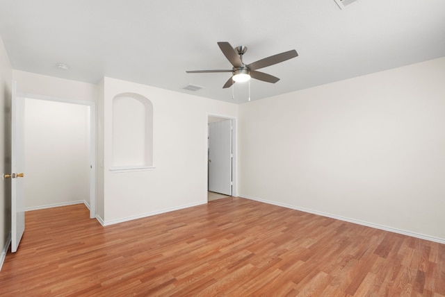 empty room with light hardwood / wood-style floors and ceiling fan