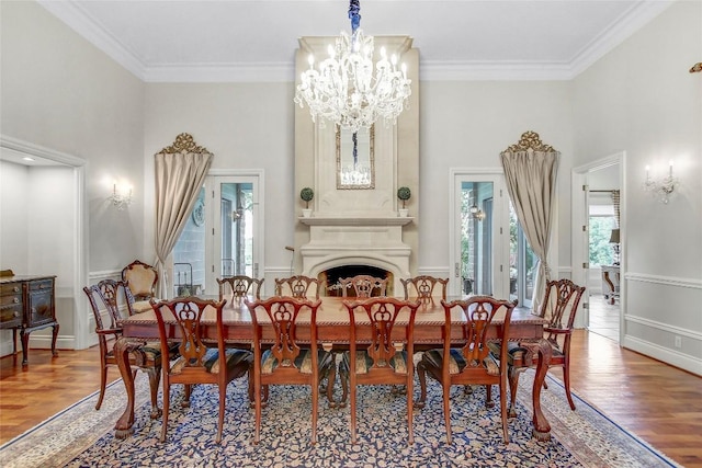 13628 Gregg Manor Rd, Manor, TX 78653 - dining area with wood finished floors, healthy amount of natural light, a chandelier, a high ceiling, and ornamental molding