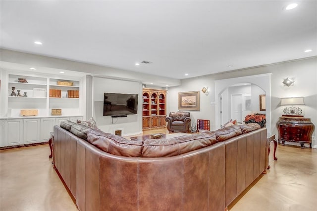 13628 Gregg Manor Rd, Manor, TX 78653 - living room featuring arched walkways, recessed lighting, concrete floors, and built in shelves