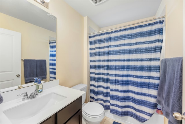 bathroom featuring toilet, vanity, tile patterned flooring, and curtained shower