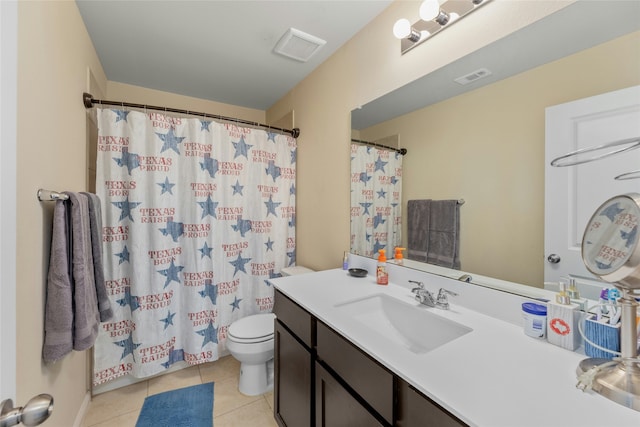 bathroom with tile patterned floors, vanity, and toilet