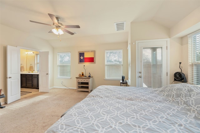 carpeted bedroom with ceiling fan, vaulted ceiling, access to outside, and ensuite bathroom