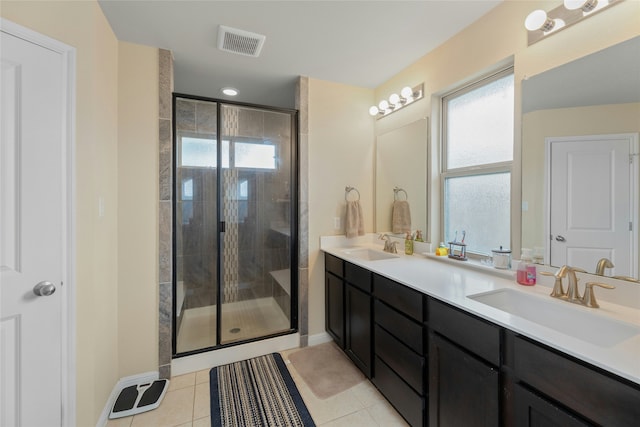 bathroom featuring an enclosed shower, a healthy amount of sunlight, and tile patterned floors