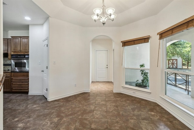 unfurnished dining area with a chandelier