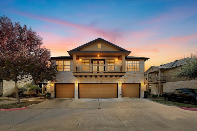 view of front of house featuring a balcony and a garage