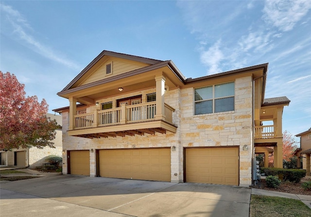 view of front of property with a balcony and a garage