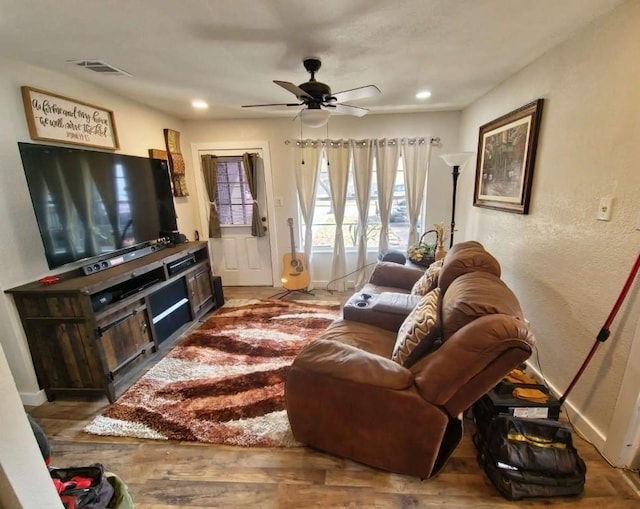 living room with hardwood / wood-style floors and ceiling fan