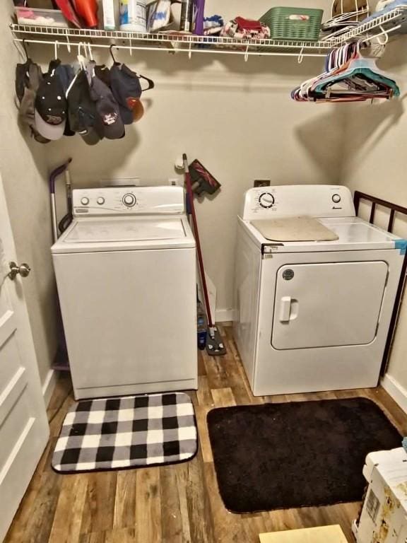 washroom featuring light hardwood / wood-style floors and washing machine and dryer