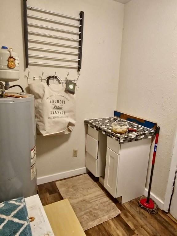 bathroom featuring wood-type flooring and electric water heater