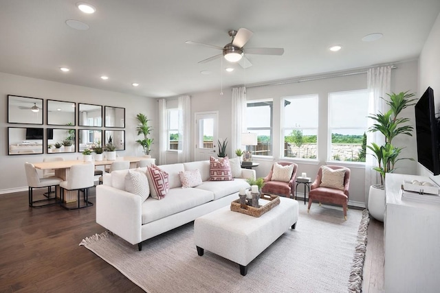 living room with ceiling fan and dark wood-type flooring