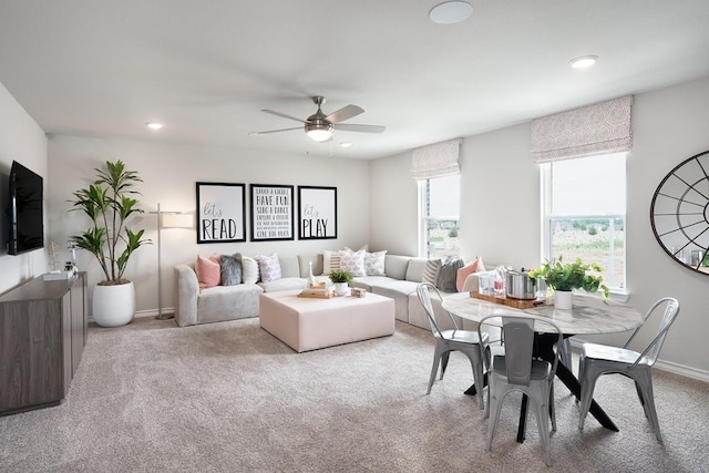 living room featuring light colored carpet and ceiling fan