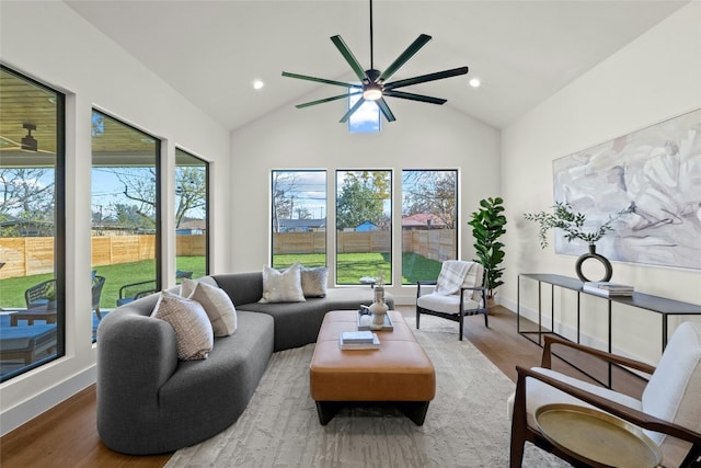 living room with ceiling fan, wood-type flooring, and high vaulted ceiling