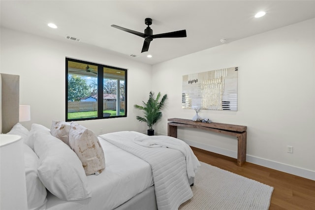 bedroom with ceiling fan and dark hardwood / wood-style floors