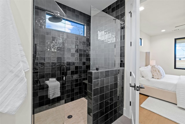 bathroom featuring hardwood / wood-style flooring and walk in shower