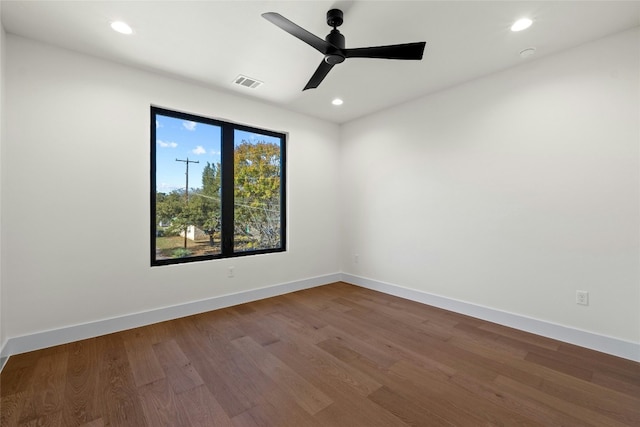 empty room featuring hardwood / wood-style flooring and ceiling fan