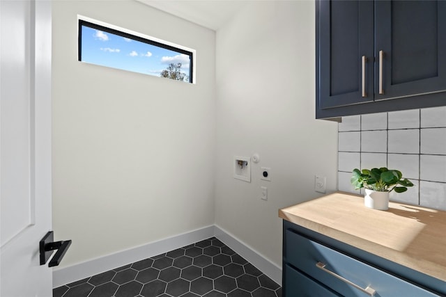 laundry area featuring electric dryer hookup, hookup for a washing machine, and cabinets