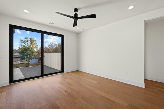 empty room featuring hardwood / wood-style flooring and ceiling fan