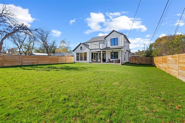 back of property featuring a patio area and a lawn