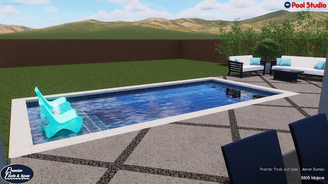 view of swimming pool with a yard, a mountain view, and a patio