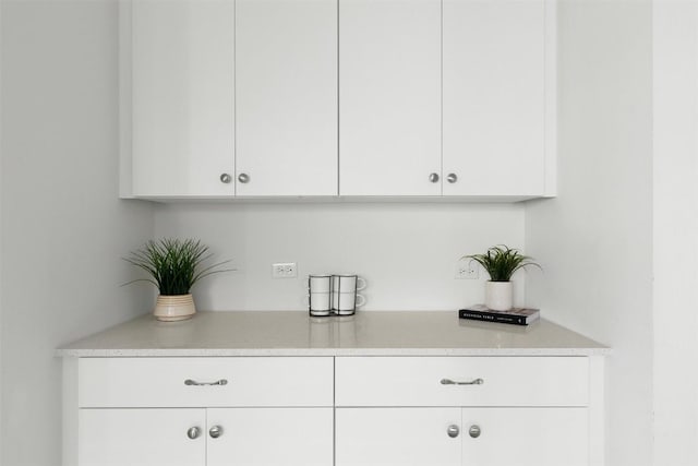 bar featuring white cabinets