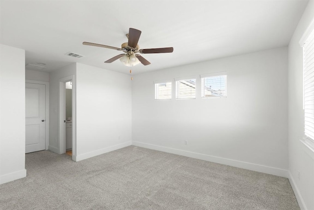 carpeted spare room with ceiling fan and a healthy amount of sunlight